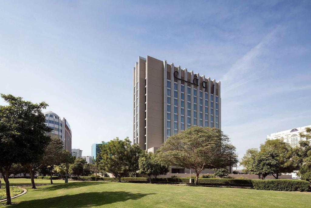 un edificio alto con un parque delante de él en Rove City Centre, Deira, en Dubái