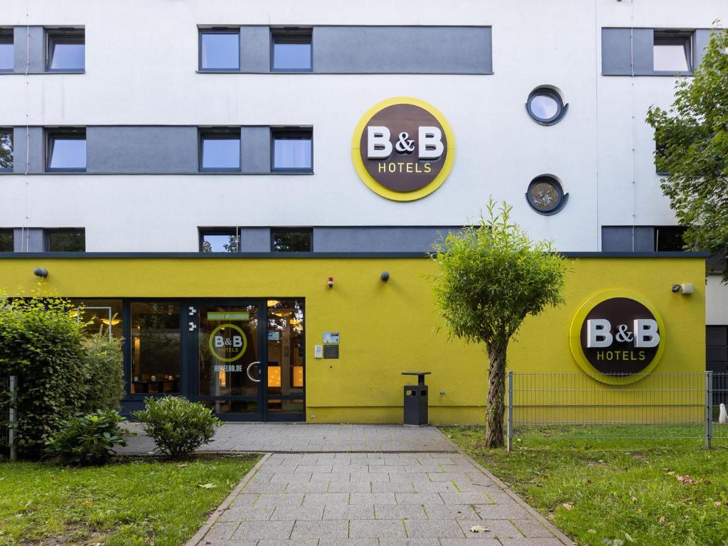 un bâtiment jaune avec un panneau d'hôtel bbb sur lui dans l'établissement B&B HOTEL Dortmund-Messe, à Dortmund