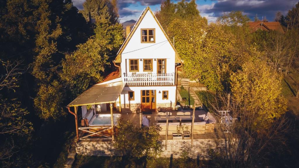 an aerial view of a white house in the trees at EgerCottages - Bikavér Cottage in Eger