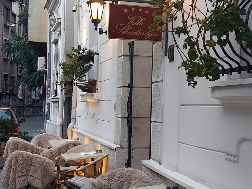 une rangée de tables et de chaises dans une rue dans l'établissement Villa Skadarlija, à Belgrade