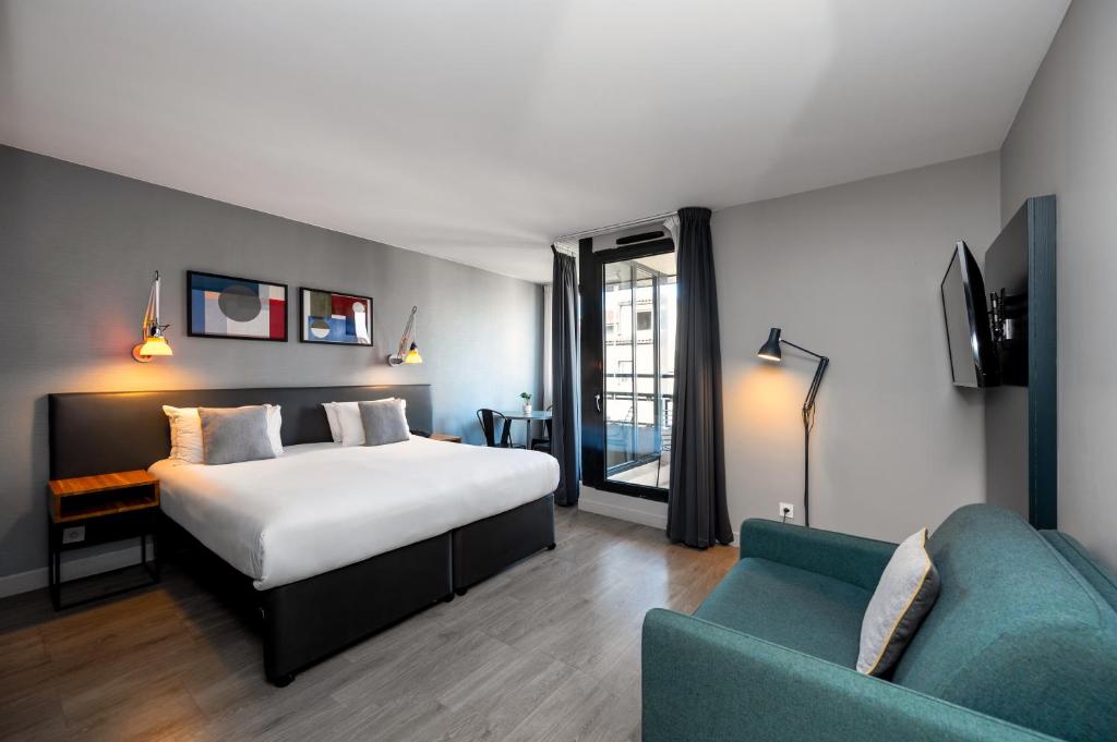 Staycity Aparthotels Marseille Centre Vieux Port في مارسيليا: غرفه فندقيه بسرير واريكه