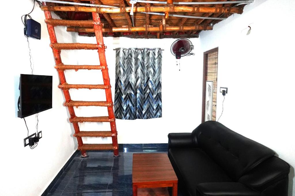 sala de estar con escalera y sofá en Serenity Bay Home Stay, en Pondicherry