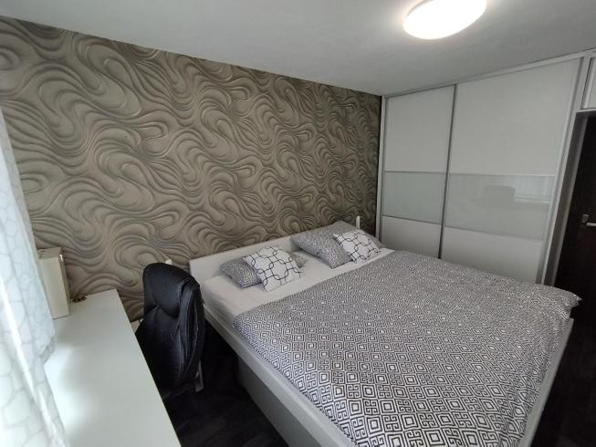 A bed or beds in a room at Prievidza Home