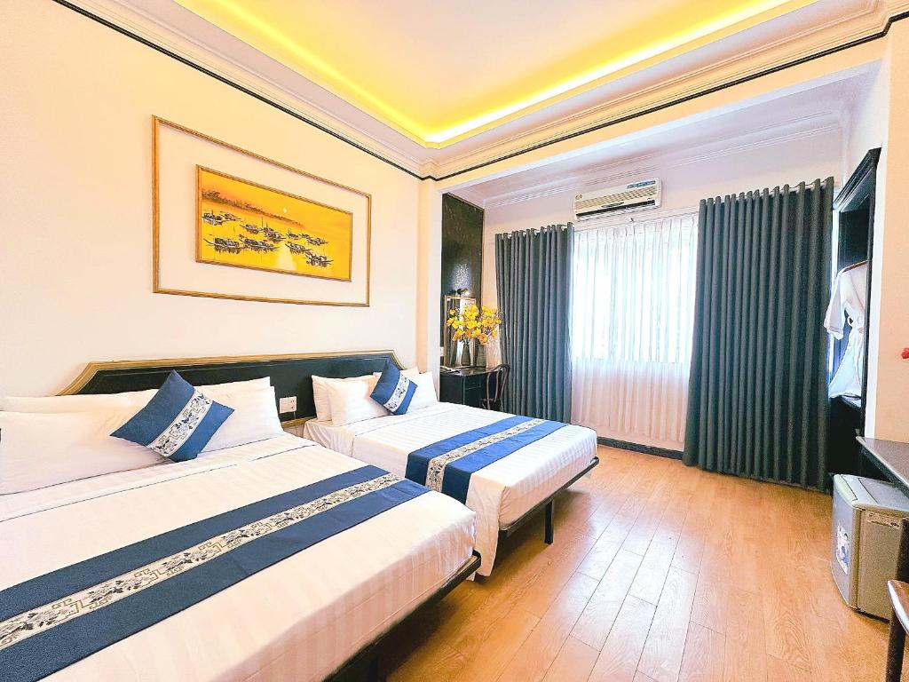 Posteľ alebo postele v izbe v ubytovaní New Star Inn Boutique Hotel-Near Bến Thành Market