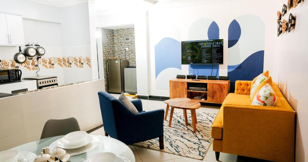 a kitchen and living room with a table and chairs at Maya Homes in Naivasha