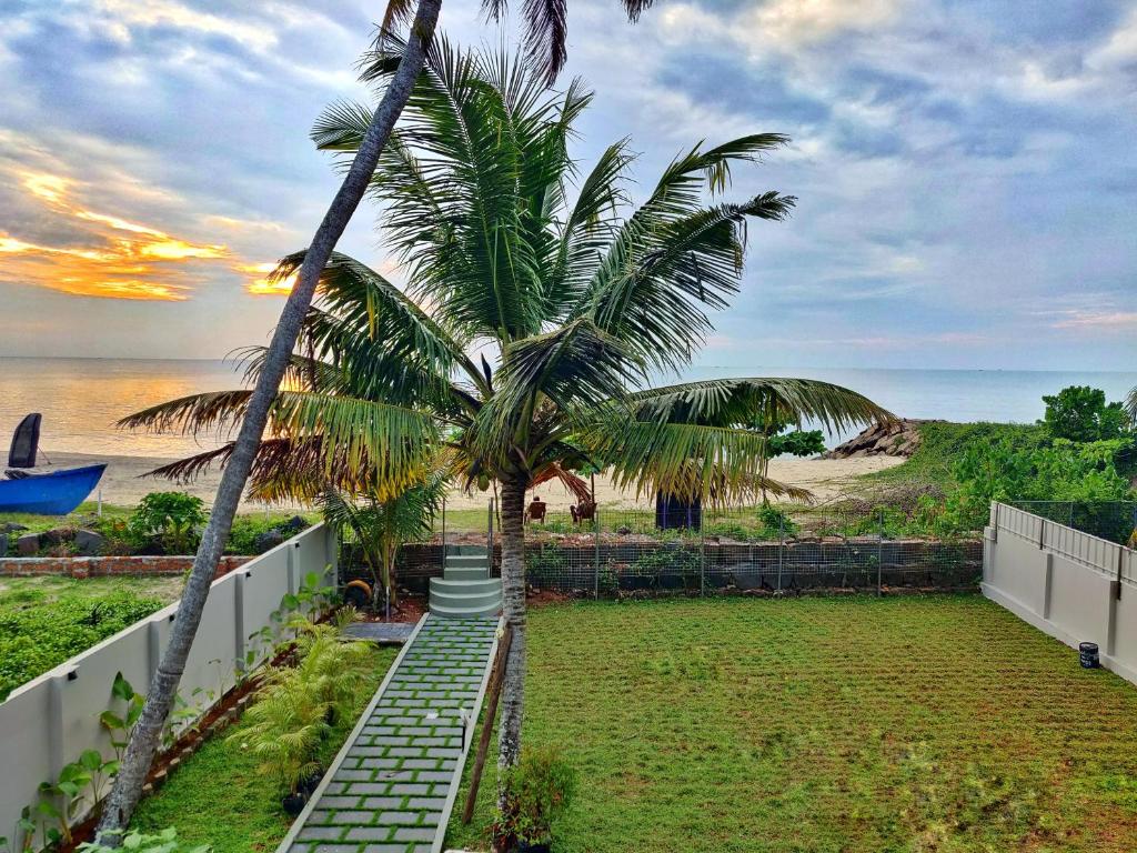 un escalier menant à une plage bordée de palmiers. dans l'établissement SHORE STORIES, à Alappuzha