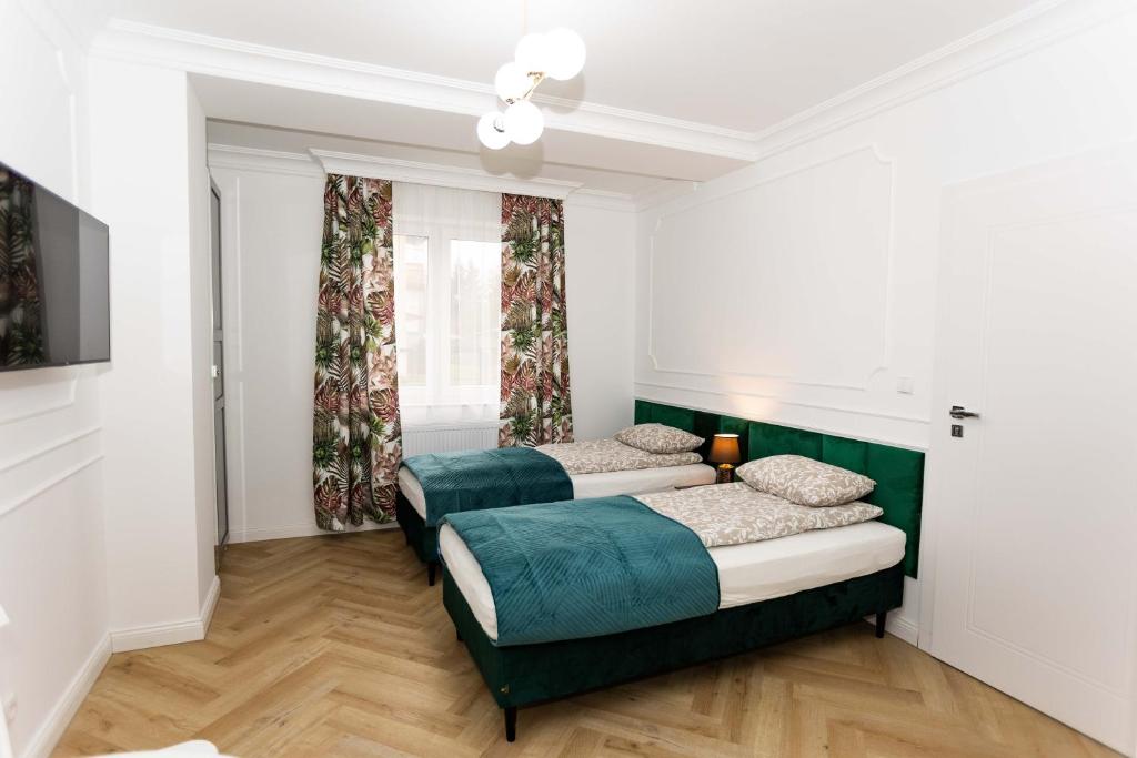 Postelja oz. postelje v sobi nastanitve Apartamenty ZZ Stargard