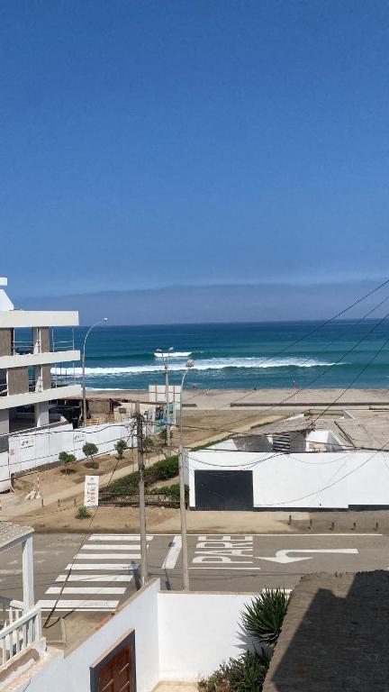 a view of the beach and the ocean from a building at Playa Norte Experience in Punta Hermosa