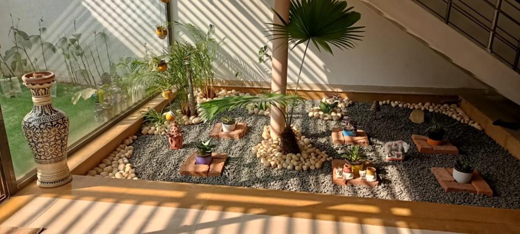 a miniature garden with potted plants in a window at Ram@nasik in Nashik