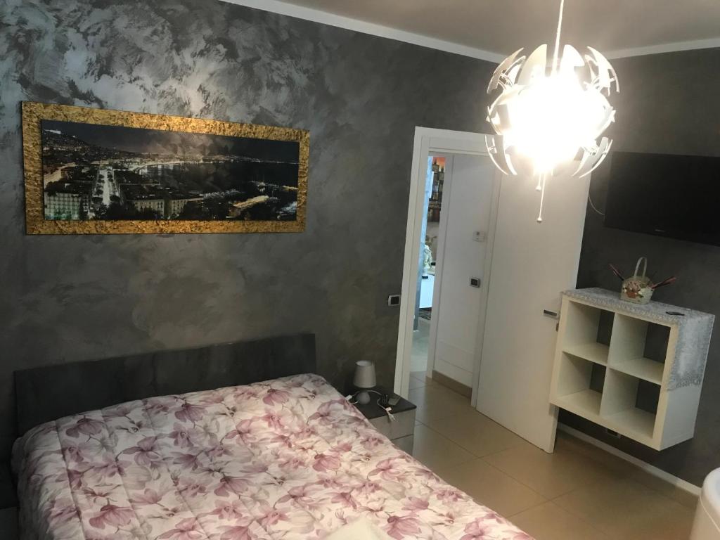 a bedroom with a bed and a painting on the wall at La casa di Elena in Sannicandro di Bari