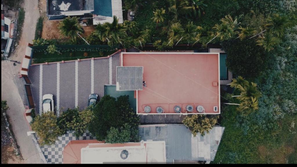 an overhead view of a building with a swimming pool at Easy Inn Wayanad in Kaniyāmbetta