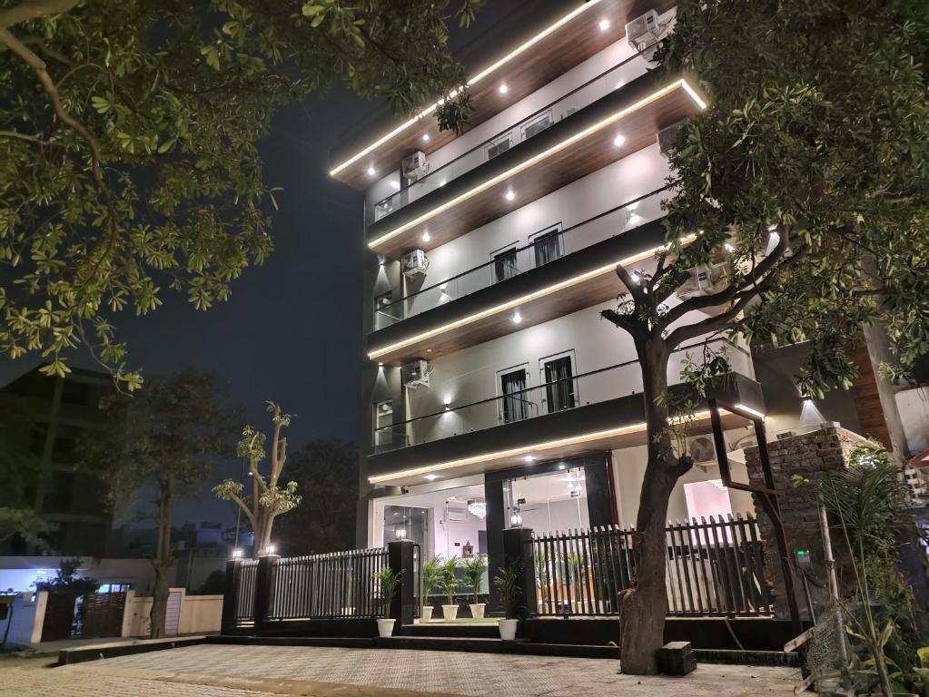 a building with lights on it at night at Emerald Suites in Greater Noida