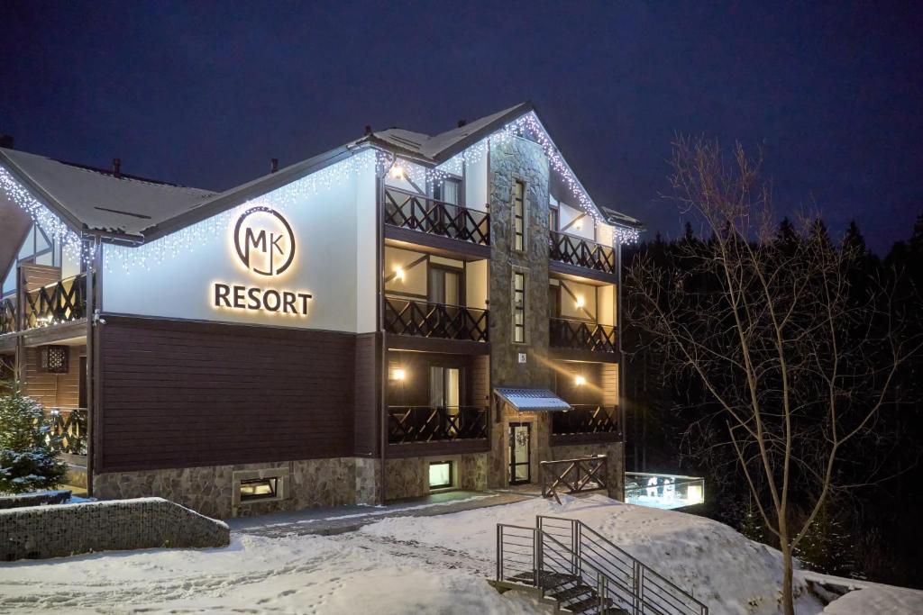 a building with a sign on it in the snow at MK Resort (ex. Magiya Karpat) in Bukovel