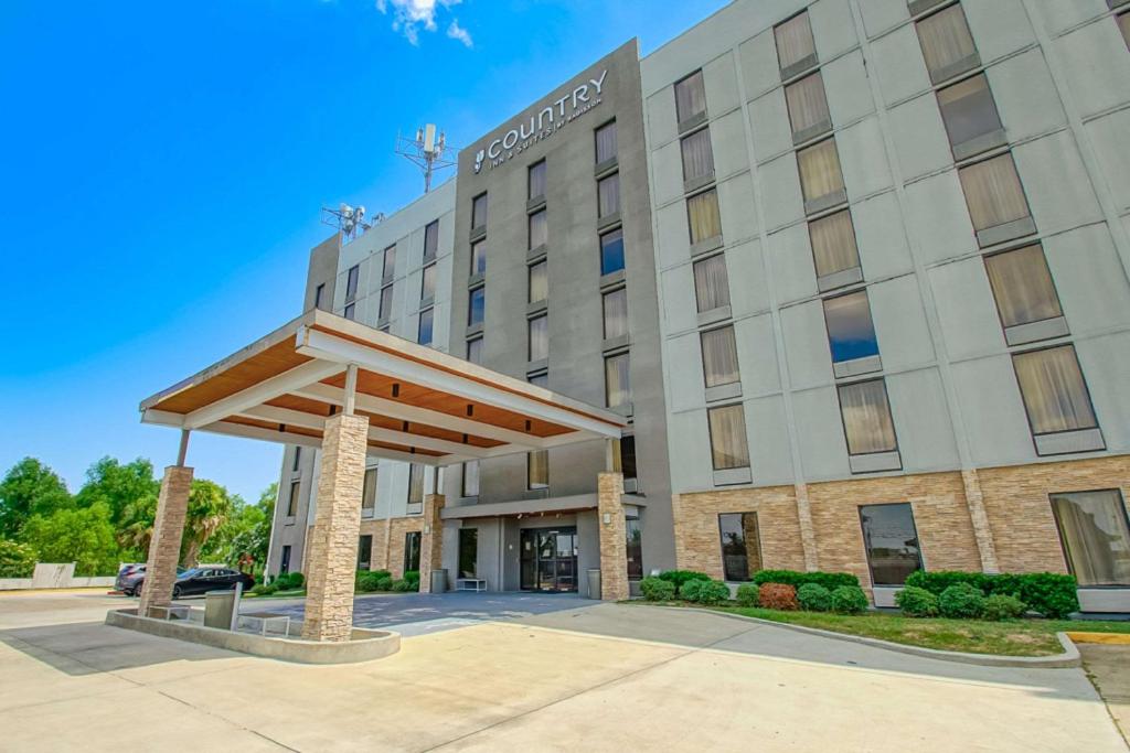 una rappresentazione della parte anteriore di un hotel di Country Inn & Suites by Radisson, New Orleans I-10 East, LA a New Orleans