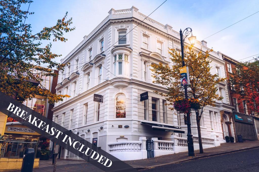 a white building with a sign in front of it at Shipquay Boutique Hotel in Derry Londonderry