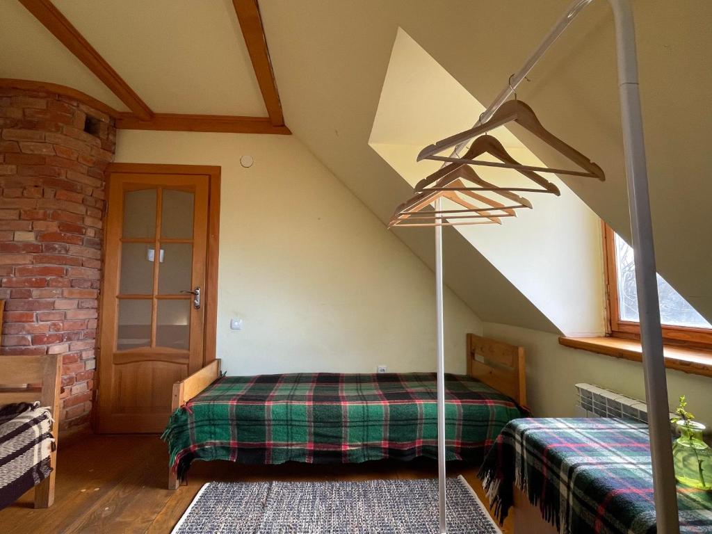 a bedroom with a bed in a attic at Tisnyi 7 Guest House in Kamianets-Podilskyi