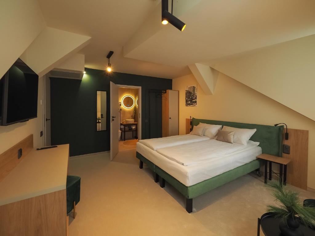 um quarto com uma cama grande e uma cabeceira verde em Craft Inn - Boutique Hotel em Sibiu