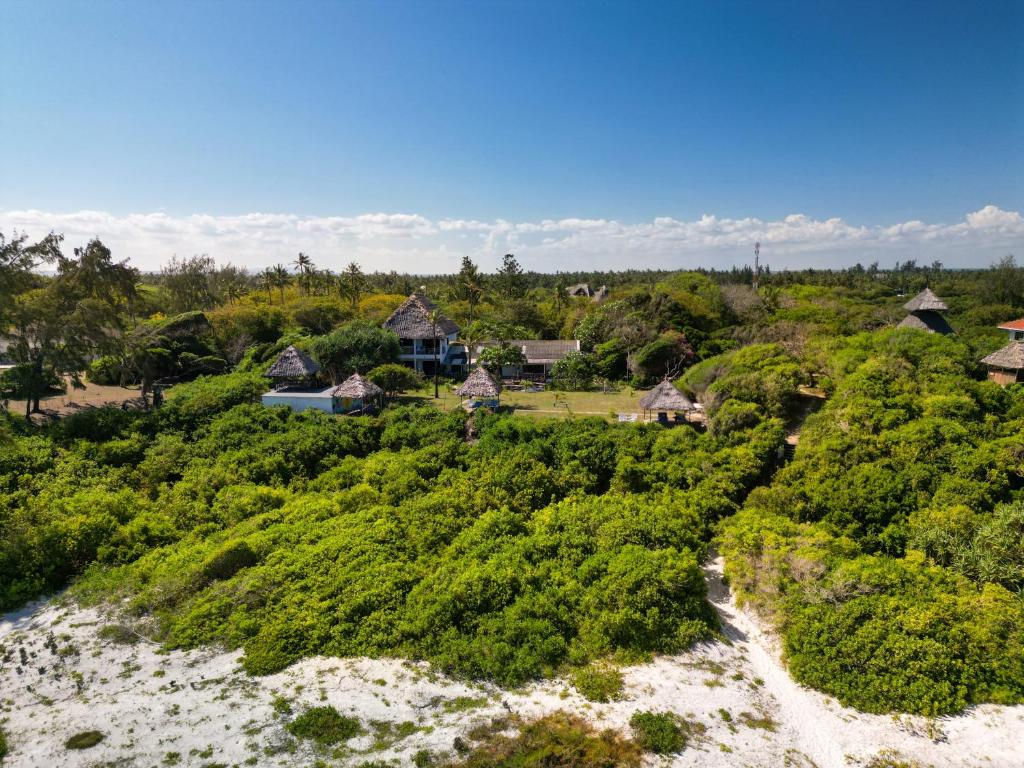 an aerial view of a resort with a river at Watamu Beach Cottages in Watamu