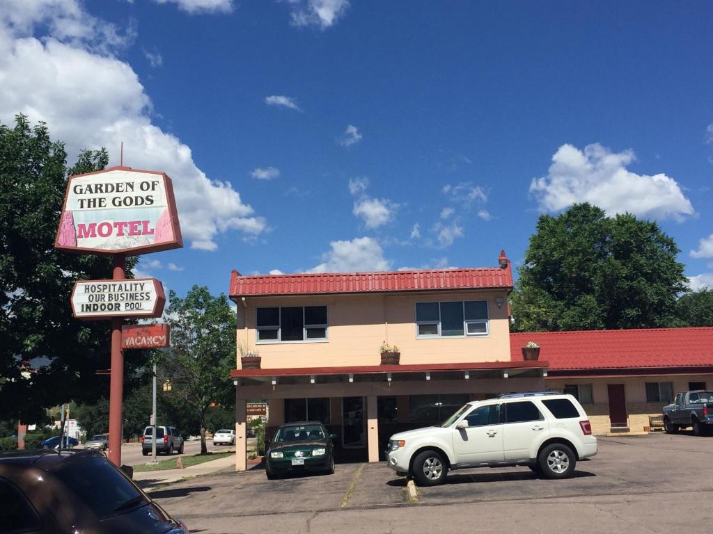 a car parked in a parking lot in front of a motel at Garden of the Gods Motel in Colorado Springs