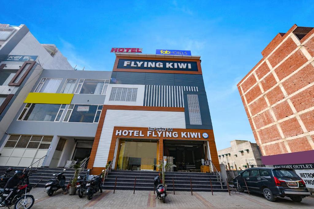 a hotel building with motorcycles parked in front of it at FabHotel Flying Kiwi in Mohali