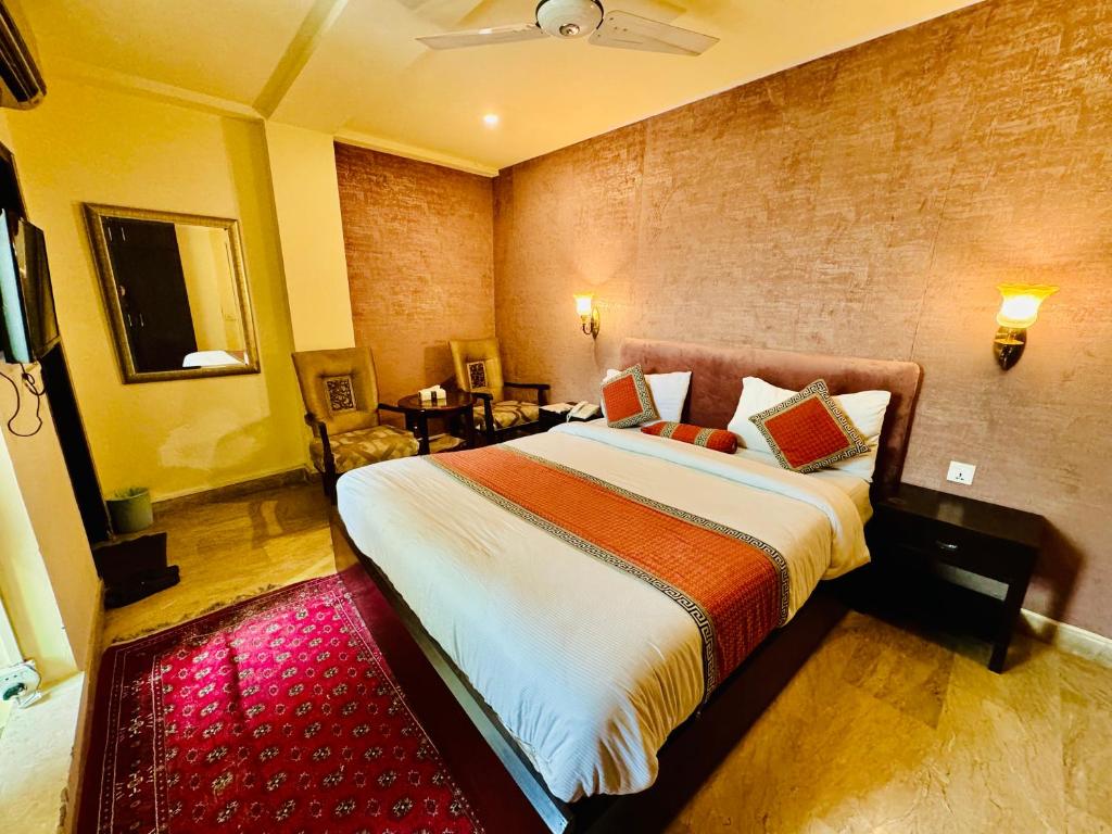 Кровать или кровати в номере Shelton Hotel Lahore