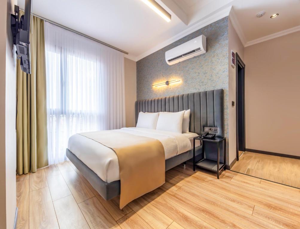 a hotel room with a bed and a window at Lenora Airport Hotel & İstanbul Airport in Arnavutköy