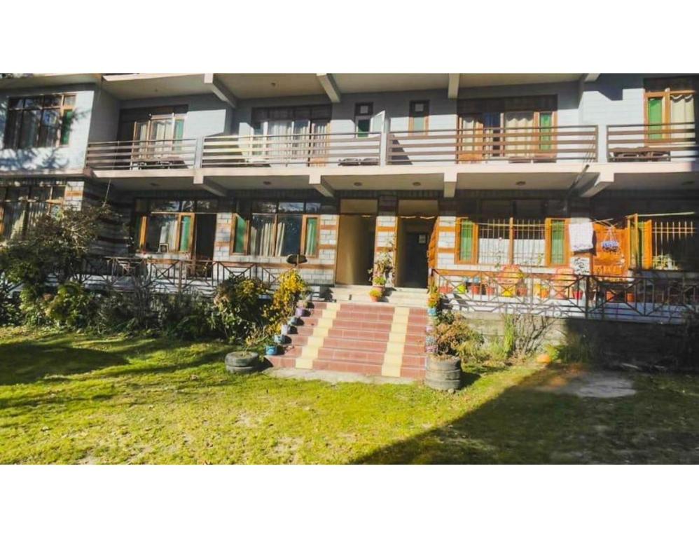 a building with a staircase in front of it at Pine Shadow Retreat, Manali in Manāli