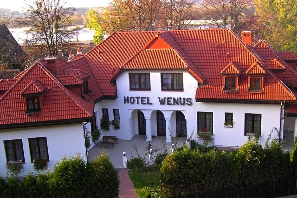 um hotel com telhado vermelho em Hotel Wenus em Kazimierz Dolny