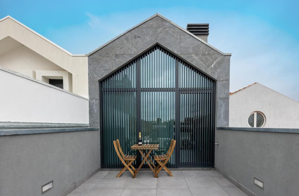 a patio with a table and chairs on a building at Live in Aveiro in Aveiro