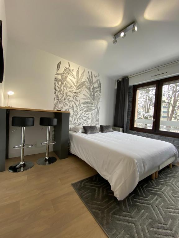 Studios & chambres aux portes de Genève में एक कमरे में एक या कई बेड