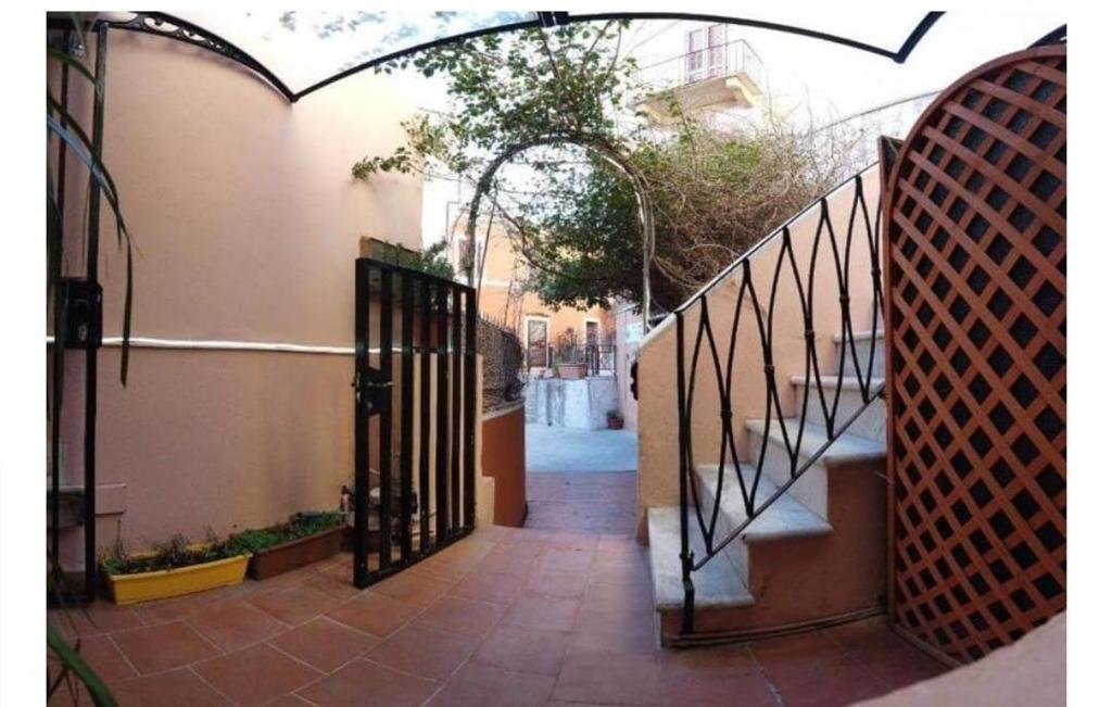 an entrance to a house with an iron gate at locanda genovese 20 in La Maddalena