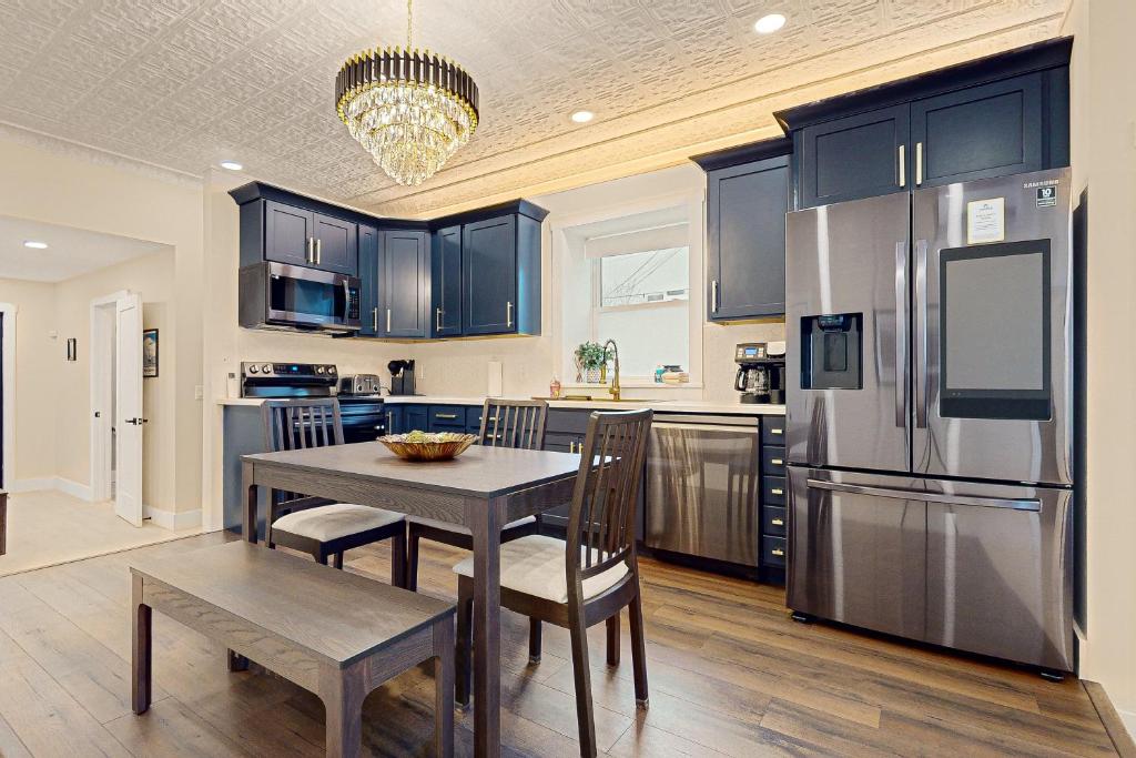 a kitchen with a table and chairs and a refrigerator at Black Pearl in Rutland