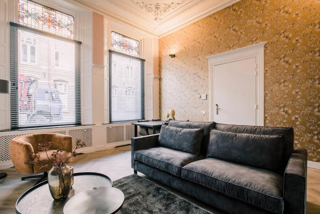 a living room with a couch and a table at Luxious Apartment Wilhelmina in Tilburg