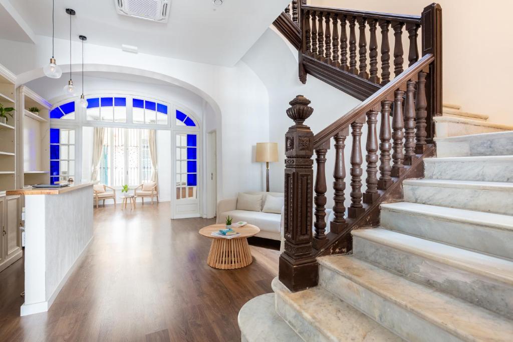 a staircase in a home with a living room at Divino Hotel Boutique in Sitges