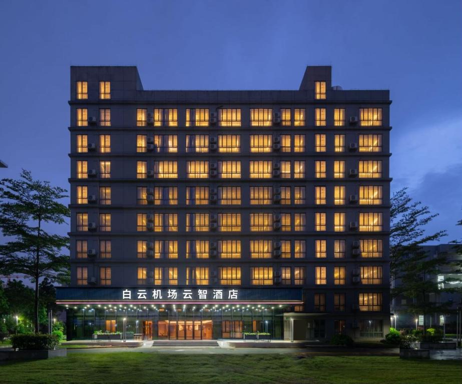 a large building with lights on at Guangzhou Baiyun Airport Yunzhi Hotel near Terminal One - Complimentary Shuttle Bus between hotel to Canton Fair Complex during Canton Fair in Guangzhou