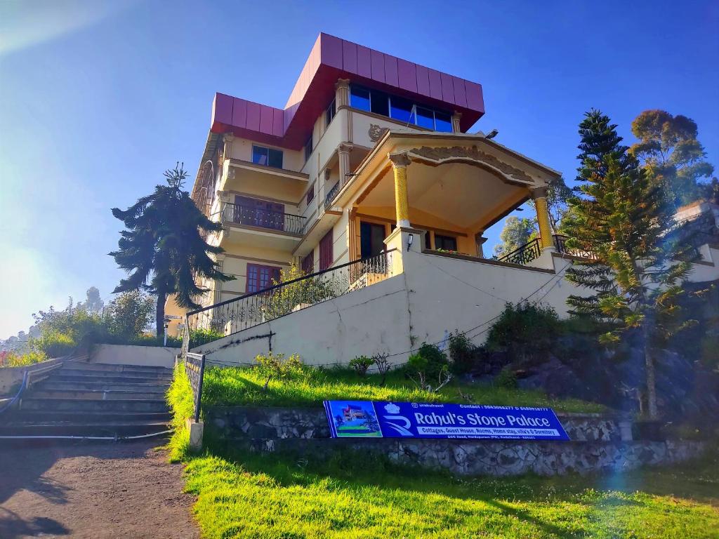 a building with a sign in front of it at RAHUL STONE PALACE in Kodaikānāl