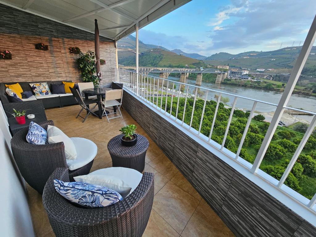 a balcony with a view of the water and mountains at Vistadouro in Peso da Régua