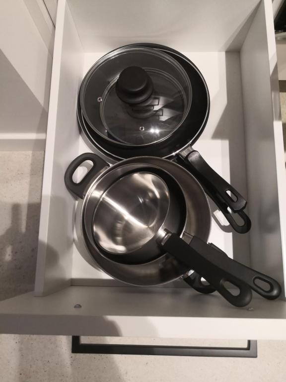 a group of pots and pans in a drawer at Apartamento céntrico Sitges, cerca de todo andando in Sitges