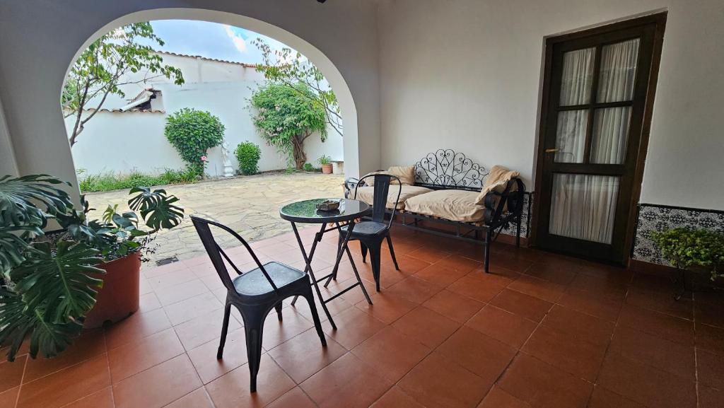 a living room with a table and chairs and a couch at La Merced in Salta