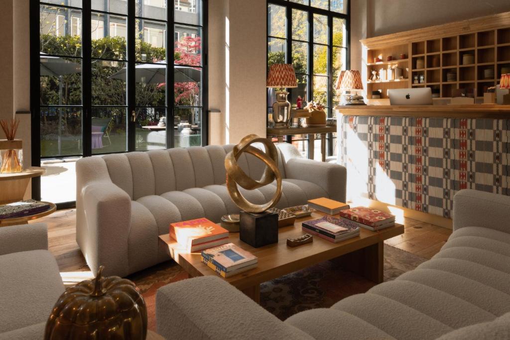 a living room with couches and a coffee table at Vmaison Brera Milano in Milan