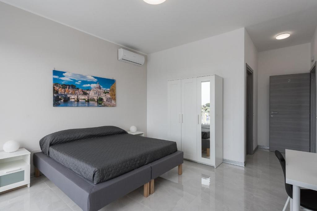 a bedroom with a bed and a table and a desk at Travelershome Ciampino Airport GuestHouse 600m to Airport in Ciampino