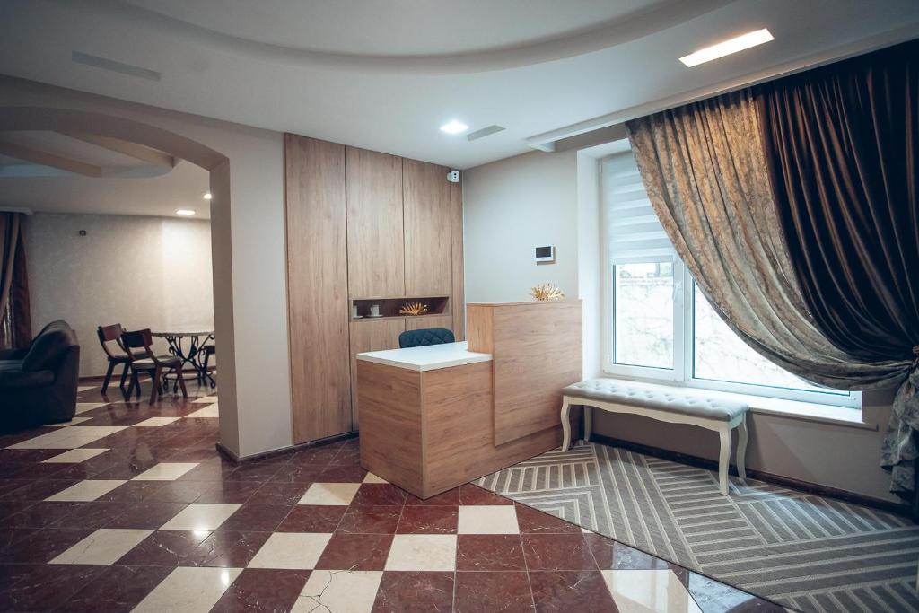 een woonkamer met een bureau en een raam bij Apart4you Hotel in Chişinău