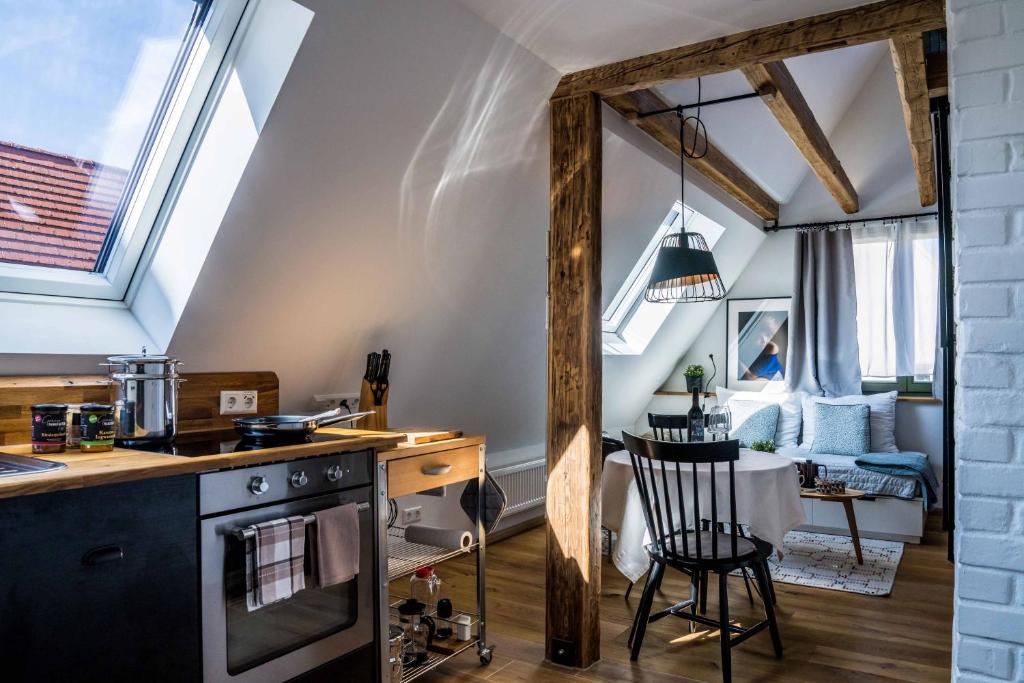 a kitchen with a table and a chair in a room at Besighomes Apartment Loft in Besigheim