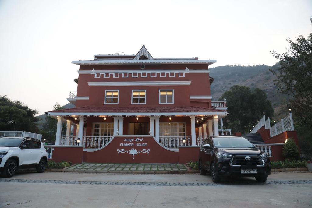 a red building with cars parked in front of it at Summer House Nandi Foothills in Nandi