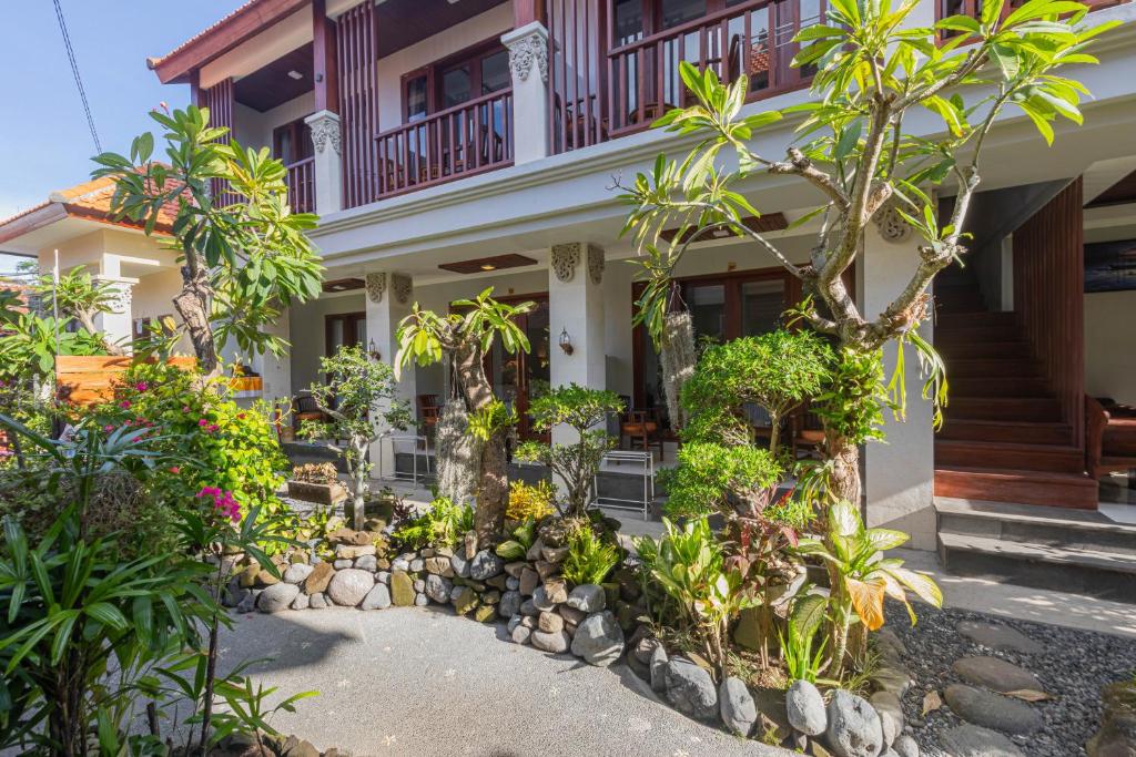 a house with trees and plants in front of it at Donahome in Sanur