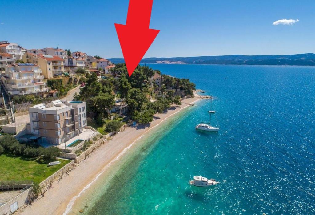 an aerial view of a beach with boats in the water at Urban Edge - Beach Apartments in Omiš