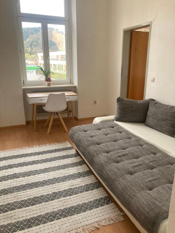 a living room with a couch and a table at JUGENDSTIL VILLA LEOBEN GÖSS - nahe SPIELBERG FORMEL 1 in Leoben