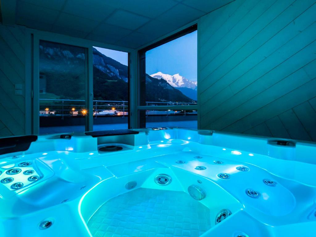 a jacuzzi tub with a view of a mountain at Ibis Styles Sallanches Pays du Mont-Blanc in Sallanches