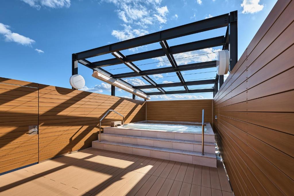 a hot tub on the deck of a house at Sauna & Capsule Hotel Rumor Plaza in Kyoto