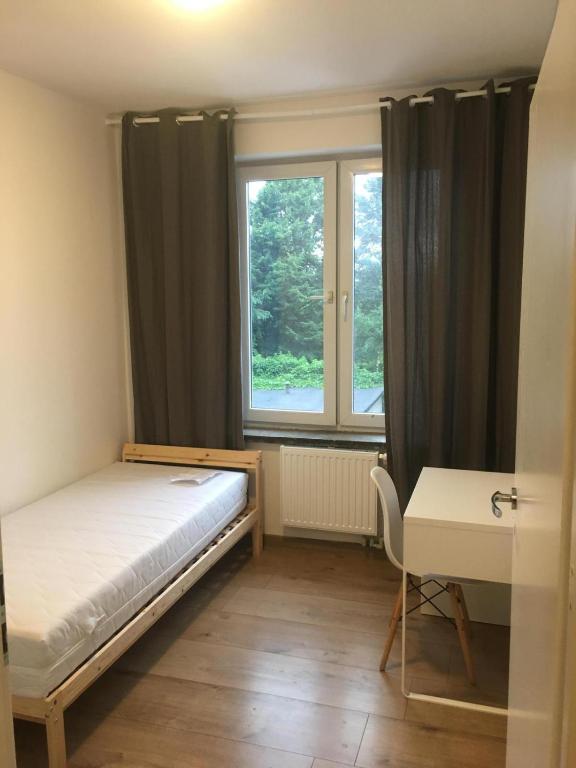 A bed or beds in a room at Hallera Wroclaw